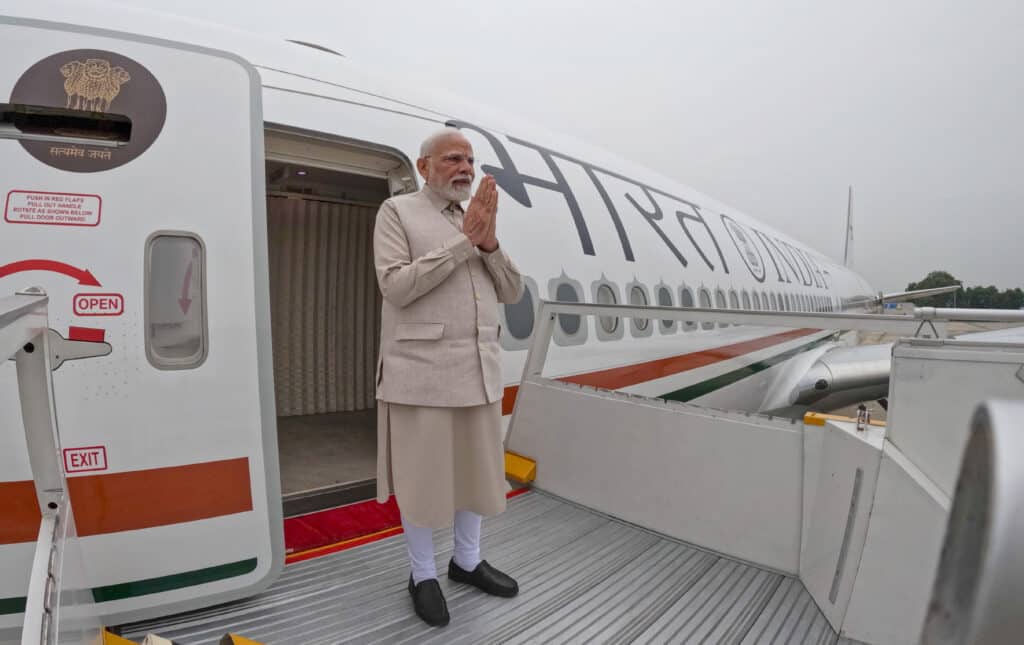 Modi Foreign Policy 2025: A Strategy, A Diplomacy, and A Global Leadership 4 Prime Minister Narendra Modi greets with folded hands while boarding the Air India One aircraft for his two-nation visit to the UK and Maldives in 2025.